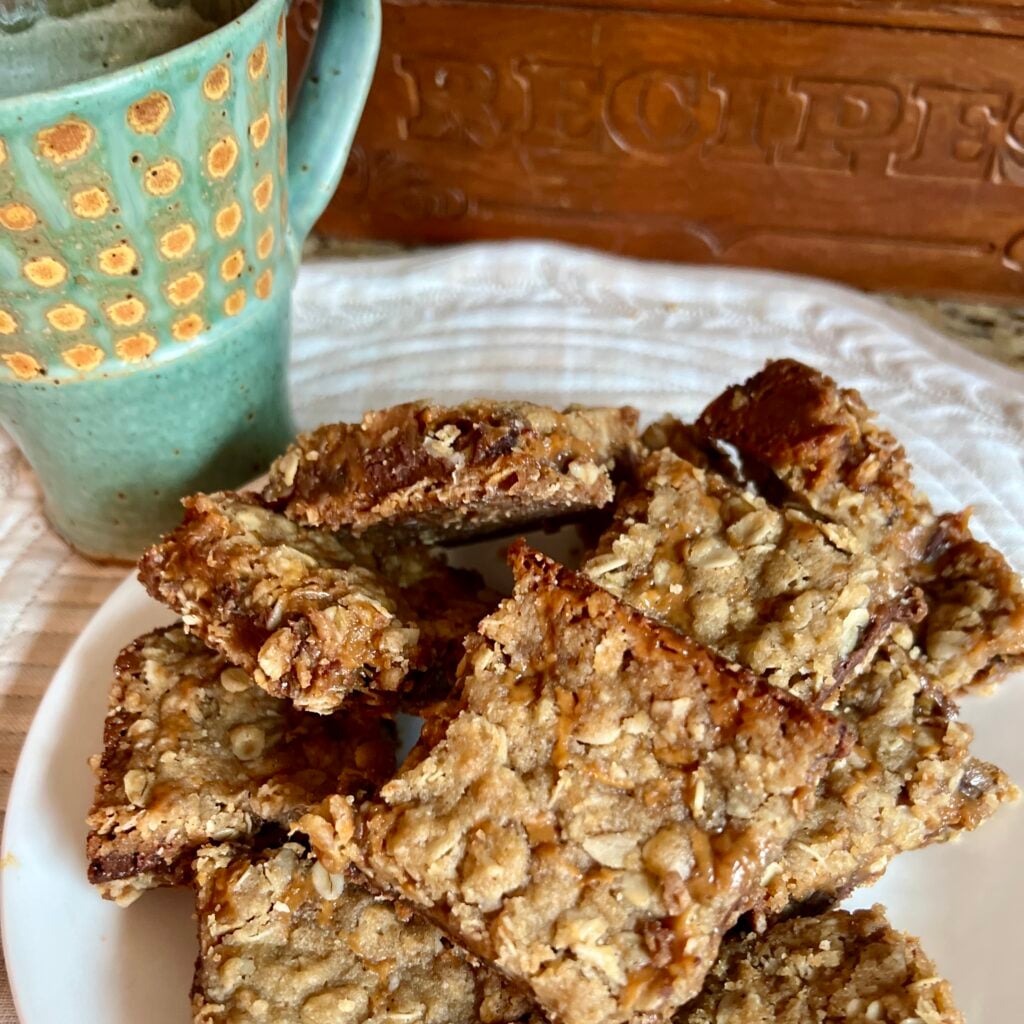 plate of carmelita cookies with a coffee cup